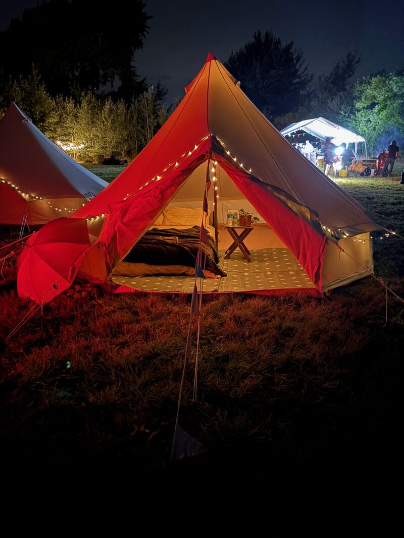 Bell tent with fairy lights at night